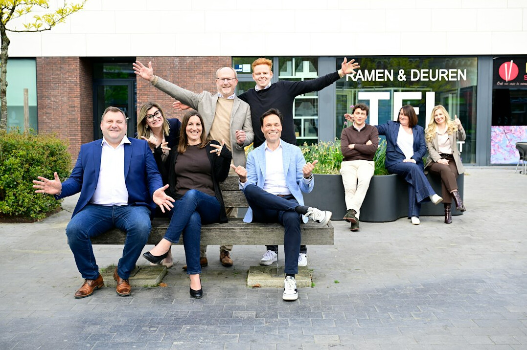 Diverse team standing together in an open office